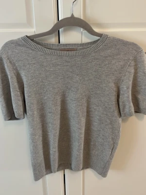 Tunnstickad grå t-shirt från hm - En finstickad t-shirt från hm i storlek s väldigt fin och skönt material. Den är använd men inte sliten