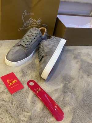 Gråa Louboutins med vita sulor  - Ett par riktigt feeta par skor ett perfekt val till er som söker efter sånna typer av skor vi har gråa inne och blåa med ljusblå! Skorna är i storlek 43 och vi fraktar o även möts upp!