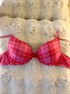 Victoria’s Secret BH  - Säljer en t‑shirt‑bh från Victoria’s Secret i modellen ”Pink Rose Plaid T-shirt bra”  Bh:n är i fint skick förutom en liten fläck på ena bandet (se bild).  Denna produkten är slutsåld på hemsidan.   Hör av dig för frågor! 🩷🤍