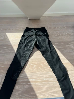 svarta ridbyxor från maya delorez - köpte för inte alls länge sedan, använda två eller möjligtvis tre gånger. I helt nytt skick. De har en midwaist och sitter under naveln på mig, väldigt bekvämt. Säljer eftersom jag inte rider längre. Tvättas såklart innan de skickas. Orginalpris är 1 599kr men mitt pris kan diskuteras.