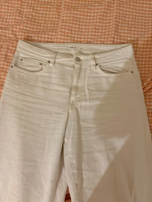 Vita baggy jeans - Säljer ett par vita jeans från ginatricot med klassisk femficksdesign och raka/baggy ben. Det är en jätte liten fläck som knappt syns och går säkert bort i tvättmaskinen, dom är verkligen super fina och är perfekt till våren och sommaren!!!🩷🩷 säljer endast därför som har blivit lite för korta för mig sen förra våren!!!🩷🩷🩷