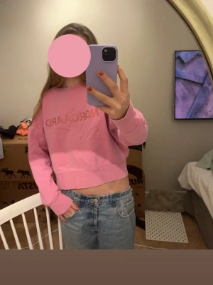 Rosa collage tröja  från Nørgaard - Säljer en rosa collage tröja från Nørgaard med tryckt logga över bröstet. Hoodien har långa ärmar, bred mudd i nederkant och är tillverkad i mjukt bomullsmaterial.  Köpt från Plick och alldrig andvänd.💕