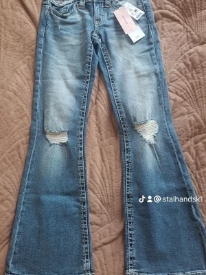 Lågmidjade jeans - Helt nya Chunky Low Flare Jeans i färgen Blue Destroy från Gina Tricot. Storlek 152. Lapparna sitter kvar och jeansen är oanvända. Låg midja och flare-passform med snygga slitna detaljer. Säljs eftersom de inte passade mig. 