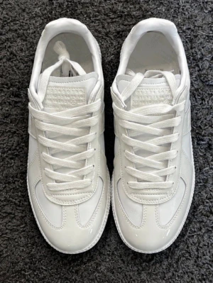 Vita Maison Margiela skor - Ett par jätte clean o fräscha maison margiellas i färgen rice white. Storlek 42. Helt nytt skick aldrig använda. Skeiv vid funderingar, pris kan dirkuteras vid snabb affär. Fraktar altid inom 24 timmar📦 