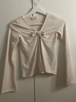 Ljusrosa topp med knut från H&M - Söt ljusrosa långärmad topp från H&M. Fint skick storlek 134/140.💕