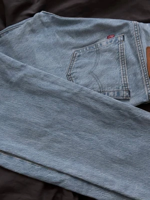 Levi's 501 ljusblå raka jeans - Klassiska Levi's 501 jeans i ljusblå denim med raka ben och femficksmodell. Storlek 30-32