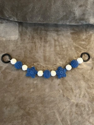 Virkat barnvagnshänge  - Virkad barnvagnshänge med blåa och vita bollar och stjärnor💞