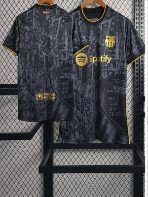 Barcelona svart matchtröja med guld - Snygg svart matchtröja från FC Barcelona med gulddetaljer och tryckta loggor för Spotify och UNHCR. Tröjan har ett unikt grafiskt mönster, klubbmärke på bröstet och texten 'MES QUE UN CLUB'. Korta ärmar och gul kant vid ärmslut och krage.