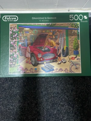 Falcon de luxe 500-bitars pussel - Säljer ett pussel med 500 bitar från Falcon de luxe med motivet 'Granddad's Garage' av Vic McLindon. Pusslet visar en klassisk bil i ett garage med familjekänsla och många detaljer. Perfekt för dig som gillar utmanande pussel och fina motiv.