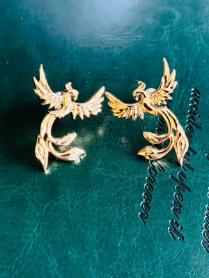 Fågel Fenix örhängen  - Fågel Fenix örhängen i rostfritt stål, okänt märke. Nya!
