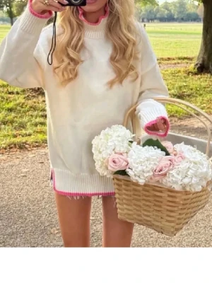 Vit oversized stickad tröja med rosa kant från meet me there - Säljer en oversized stickad tröja i vitt med rosa detaljer vid hals, ärmslut och nederkant. Tröjan har en avslappnad passform och långa ärmar, perfekt för en trendig och mysig look.