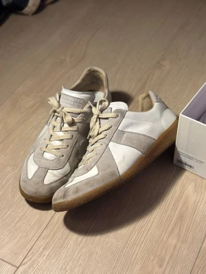 Maison margiela gats  - Halloj! Nu finns dessa fina Maison margiela gatsen i den traditionella vita färgen till salu:) Dem är i bra skick utan några nämnvärda defekter utanför det vanliga användnings tecknena som skor får. Storlek 44. OBS dem är INTE äkta, men dem är i den absolut bästa batchen för Mm Gats som finns. 