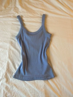 Tajt blått linne  - Säljer detta tajta linnet från Gina Tricot i storlek XS.