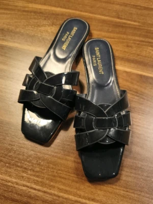 YSL sandals  - YSL Tribute Sandals in navy/purple. Have been walked with indoors for a try-on. Amazing quality. Size 37, but can be worn up til size 40 since it is a sandal and open toe.