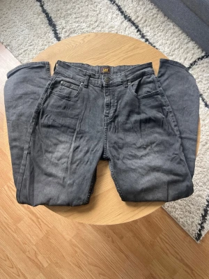 Gråa Lee jeans - Hej👋 Säljer ett par grå jeans från Lee med klassisk femficksdesign och raka ben👖 Jeansen har normal midja och är tillverkade i bomull med en liten Lee-logga på bakfickan😮‍💨 Perfekta för en avslappnad och stilren look🤩 Meddela vid frågor📩