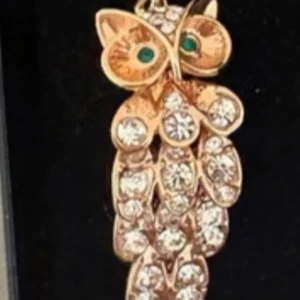 Unikt Glittrigt ugglearmband i Roséguldton - Unikt armband med en uggla i Roseguldton, dekorerad med gnistrande stenar och gröna detaljer i ögonen. Kedjan är tunn och smidig, och ugglan har en cool, detaljrik design som verkligen sticker ut. Perfekt accessoar för dig som gillar djurmotiv och bling.