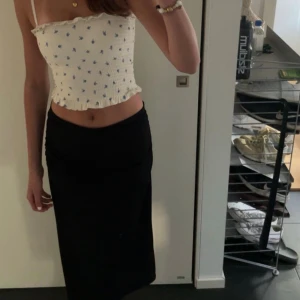 Vit bandeau topp med blommor - Vit bandeautopp med blåa blommor från H&M. Lappen är borta men passar XS/S. Använd fåtal gånger. 