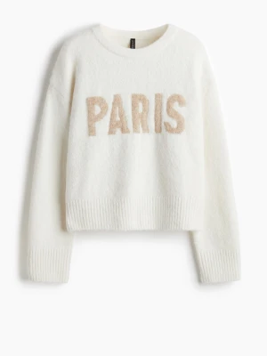 Vit stickad tröja med PARIS-tryck - Mysig vit stickad tröja från Divided med beige text 'PARIS' framtill. Tröjan har rund hals, ribbade muddar och är långärmad. Perfekt för dig som gillar enkel och trendig stil med en touch av Paris. Pris kan diskuteras vid snabb affär! 