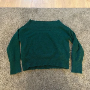 Mörkgrön stickad tröja - Mysig mörkgrön stickad tröja, är nopprig.