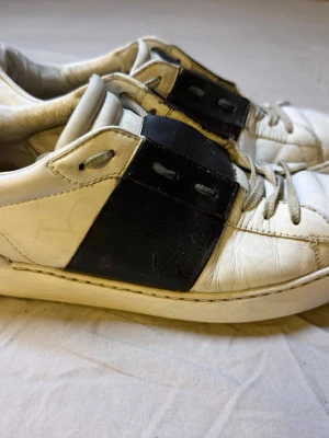 Valentino Open sneakers svart/vit – Strl 44  - Sjukt snygga Valentino Open sneakers i svart och vitt, storlek 44. Klassisk och exklusiv modell som passar till både jeans, chinos och mer uppklädda outfits.  Skorna är använda men har mycket kvar att ge. Perfekta för dig som vill ha lyx-sneakers till ett bättre pris.  • Märke: Valentino • Modell: Open • Färg: Svart/Vit • Storlek: 44  Valentino 1