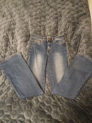 Blå bootcut jeans från Denim - Säljer ett par klassiska blå bootcut jeans från Denim. Jeansen har normal passform, medel weist.. Snygga slitningar framtill och bakfickor med enkel design. Der fins två små hål som man Swedbank på sista bilden hålet är nere. Der är storlek 38 men om du har 36 så passar dom ochså för att jag bör ivanligafal 36 ❤️ skriv för frågor eller mått ❤️
