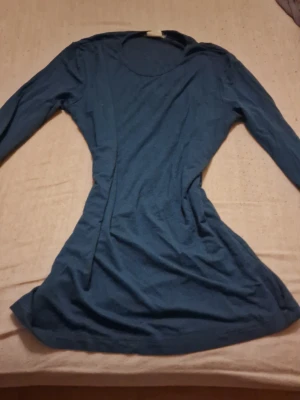 Mörkblå långärmad topp med nitar - Snygg mörkblå långärmad topp med rund halsringning. Ärmarna är dekorerade med små silvriga nitar och stenar som ger en cool och unik touch. Perfekt att styla med jeans eller kjol för en trendig look. Den har en tight passform för dig med storlek S. Osäker på märke. Priset som står gäller, kan möjligtvis diskuteras🫶