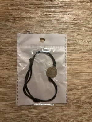 Dompa armband - Den är helt ny. Man kan justera hur stor den ska vara så att den passar alla. På metall biten är motivet dompa alltså champagnen.