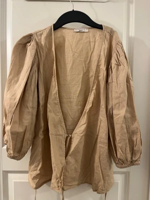 Linen blend top med puffiga armar  - Linen blend top med puffiga armar och band runt midjan. Jätte söt och chic