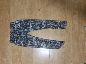 Nike svarta leggings med grafiskt mönster - Nike leggings i svart med grått grafiskt mönster och logga på höften. Stretchigt material som sitter tight och följer kroppen. Perfekta för träning eller chill, med elastisk midja för skön passform.