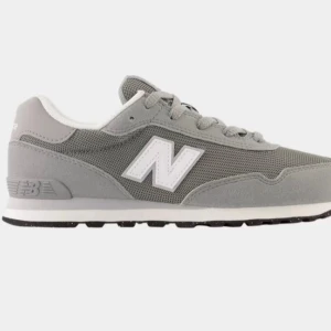 Grå New Balance sneakers - Snygga grå sneakers från New Balance med klassisk vit N-logga på sidan. Skorna har snörning, platt sula och är tillverkade i en mix av mesh och syntetmaterial för en sportig och stilren look. Perfekta för dig som gillar streetstyle och komfort.