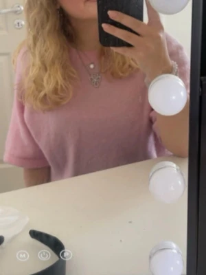 Ljusrosa stickad tröja med halvärm - Säljer en ljusrosa stickad tröja med halvärm och rund hals. Tröjan har en loose passform och är supermjuk, perfekt för både vår och höst. Enkel och stilren design som är lätt att matcha med olika outfits.