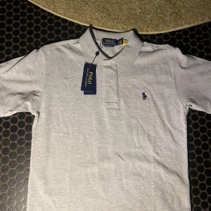 Grå pikétröja från Polo Ralph Lauren - Säljer en helt ny Grå Polo Ralph Lauren Piké 👕Bara höra av er vid frågor/funderingar Priset kan diskuteras