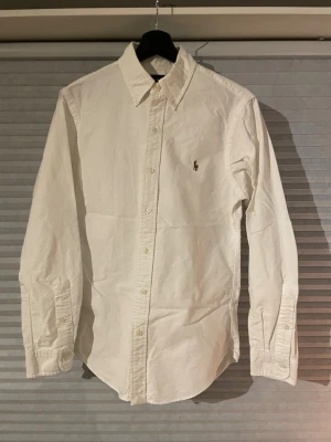 Vit skjorta från Ralph Lauren Slim Fit - Klassisk vit skjorta från Ralph Lauren i slim fit-modell. Sparsamt använd och säljs då den blivit för liten. Pris 329kr //David