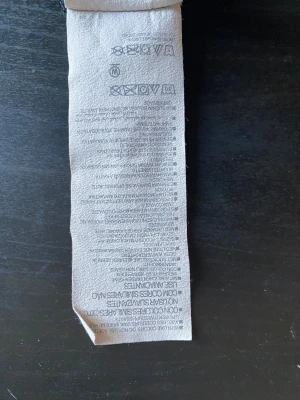 Svart träningströja Under Armour -storlek Small - Svart kortärmad träningströja från Under Armour i loose fit. Tröjan har diskret mönstrad yta och klassisk rund hals. Materialet är polyester, vilket gör den lätt och skön för aktiva dagar. Loggan syns både fram och bak för en sportig vibe.