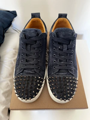 Mörkblå Louboutin sneakers med nitar - Säljer nu dessa sjukt feta Christian Louboutins då dom ej kommer till användning längre och intresset svalnat. Sällsynt färg på dessa och sparsamt använda. 