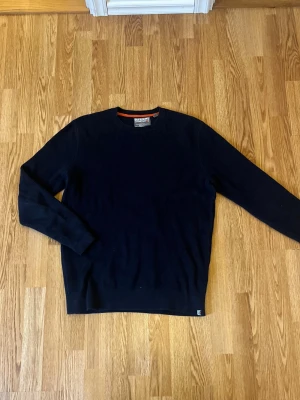 Mörkblå stickad tröja Superdry XL - Säljer en mörkblå stickad tröja från Superdry i storlek XL. Tröjan har en grovstickad struktur, rund hals och långa ärmar. Perfekt för dig som gillar enkel och stilren design med diskret logga vid nederkanten.