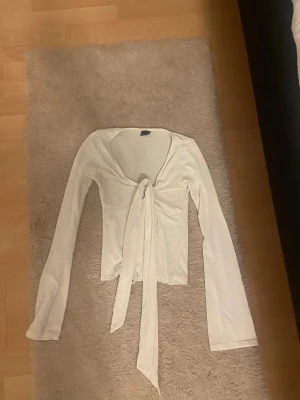 Vit topp med knyte där fram från Gina - Superskön