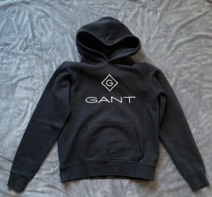 Svart Hoodie från Gant - Säljer min svarta Hoodie från gant. Nästan helt ny då jag nyligen hittade den i min garderob. Perfekt till någon som vill ha en helt ny hoodie för en bra peng. 