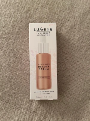 Lumene Instant Glow Beauty Serum - Lumene Invisible Illumination Instant Glow Beauty Serum i färgen Universal Tan. Kommer i en glasflaska med pipett och har en naturligt solkysst ton. Serumet är veganskt och ger en fräsch glow till huden. Innehåller 30 ml och passar alla hudtyper. Helt oanvänd förbaka fick fel färg. Gick inte att returnera:(