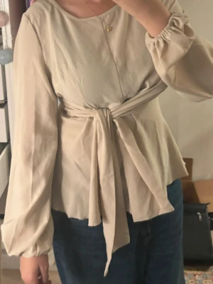 Beige wrap blouse - The color is a little mixed with beige and yellow, it really depends on what pants you wear. Other than that it’s very comfortable