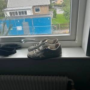 Gråa Golden Goose sneakers mocka - Säljer ett par gråa Golden Goose sneakers i mocka med vit stjärndetalj på sidan. Fikt skick storlek 41. Öppen för byte