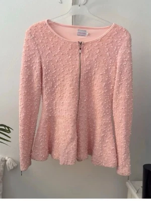 Vackert gnistrande kofta, fodrad. - Väldigt vacker oanvänd kofta med rejäl dragkedja, fodrad. Färgen är aprikos och det gnistrar om den(paljetter). Sanningsenlig i storlek. Passar S/M, 36/38.