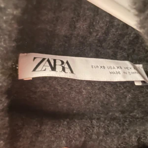 Grå polotröja från Zara XS - Mysig grå polotröja från Zara i storlek XS. Tröjan har en hög, ribbad krage och är långärmad med en loose fit.