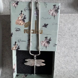 Silverfärgat halsband med trollslända - Unikt halsband från ioaku med en silverfärgad kedja och ett detaljerat trollslände-hänge. 