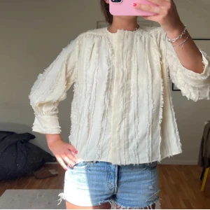 Krämig beige/vit blus med fransiga detaljer från Wera - Storlek 34, passar mig som har S. Aldrig använt! Bilden är lånad💕💕
