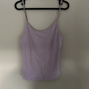 Ljuslila ribbad linnetopp - Säljer en ljuslila ribbad linnetopp med smala axelband. 