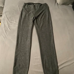 Mörkgrå leggings - mörkgrå leggings med medel hög midja och smal passform. Materialet är mjukt och stretchigt