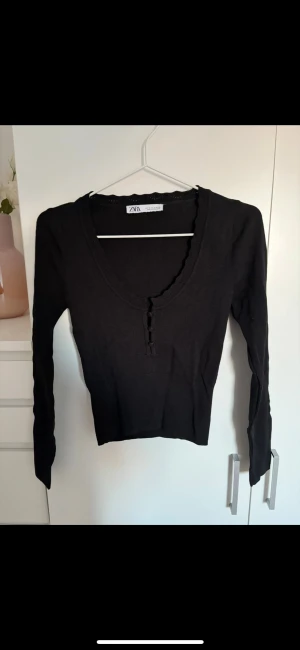 Svart ribbad topp med knappar från Zara - Svart långärmad topp från Zara i storlek S. Endast testad 