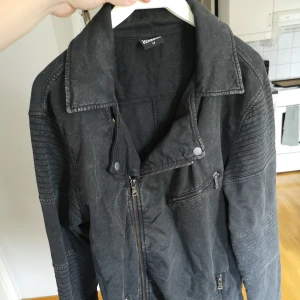 Biker jacka - Säljer en jacka i biker stil. Sliten look. Använd 1 gång. Tygjacka. Storlek Medium. 