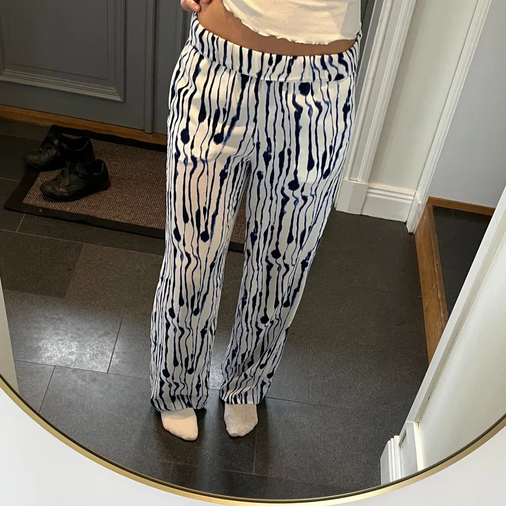 Vita/blå mönstrade byxor från H&M i storlek 36. Passar mig som är 172 och brukar ha S eller M. Fint skick. Använd gärna köp nu!. Jeans & Byxor.